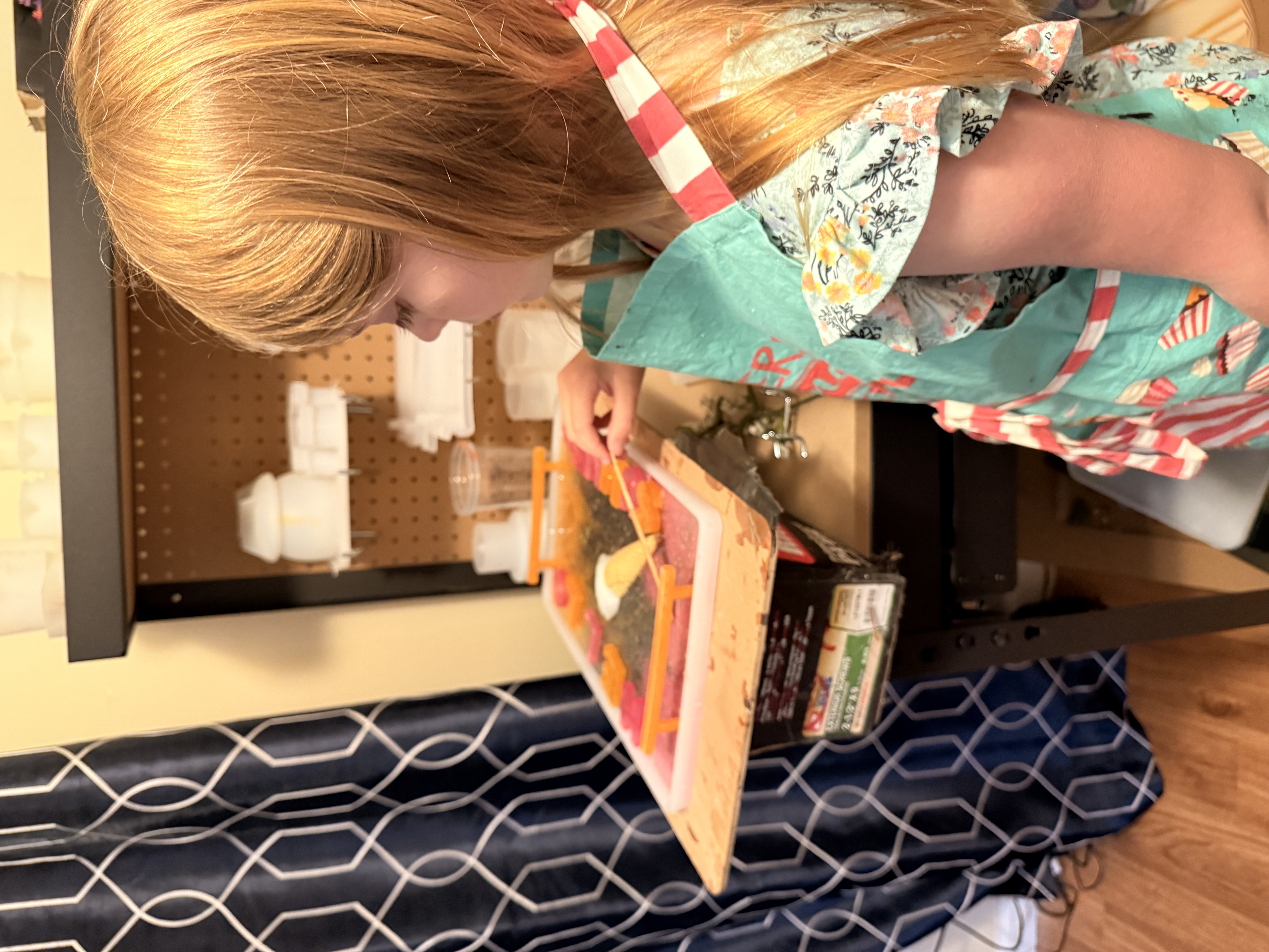 Cora working at her resin art station